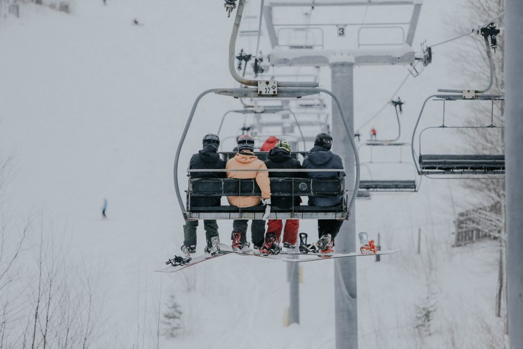 Snowboarders on a chair lift at Hunter Mountain, NY