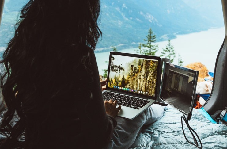 digital nomad with laptop with two screens