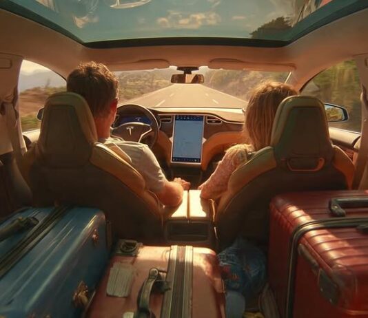 family in a tesla using autopilot on vacation